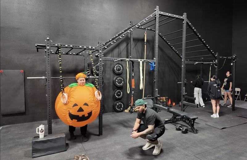Squats and ring work at the rig during a Halloween class at ATG Fitness